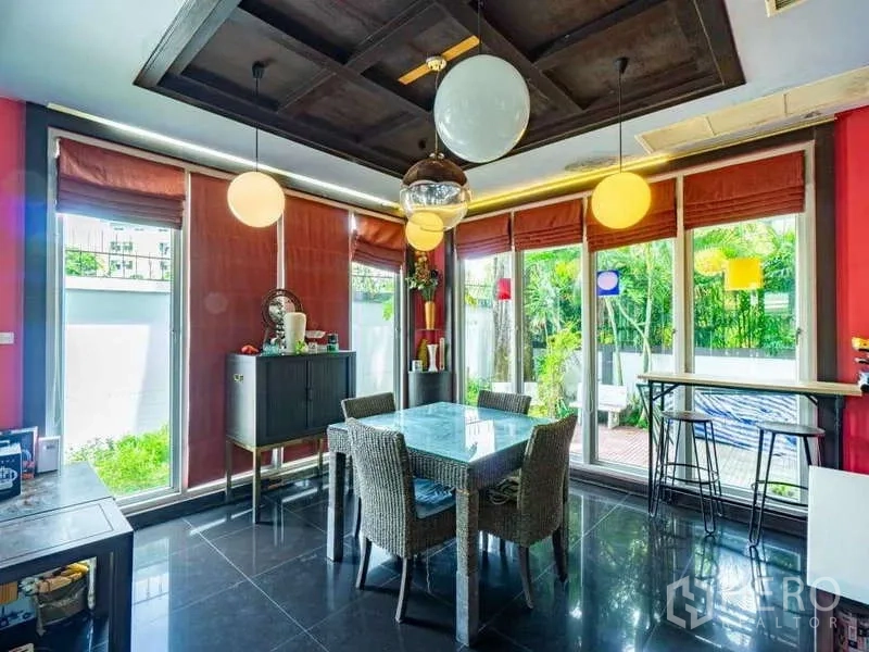 Detached House for sale in Suan Luang, Bangkok - Bright dining room with glass table, globe pendants and garden views.