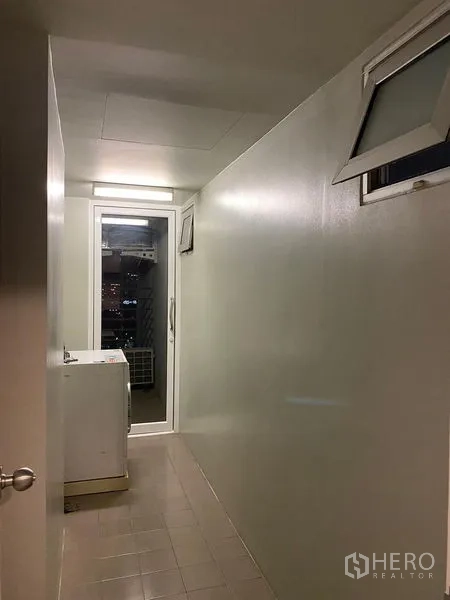 Condominium for rent - Utility balcony with washing machine and glass door providing ventilation.