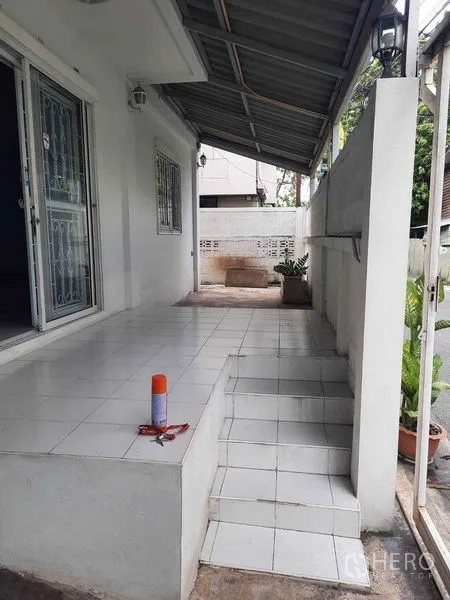 Home Office for rent in Watthana, Bangkok - Front porch with roofed terrace, steps, and sliding door.
