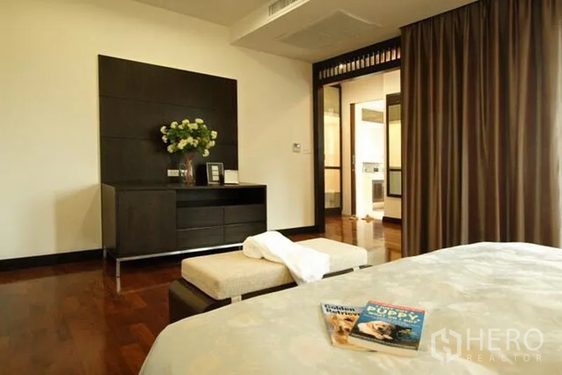Condominium for rent in Watthana, Bangkok - Spacious master bedroom with hardwood floors, built-in console, full-length curtains and ensuite access.