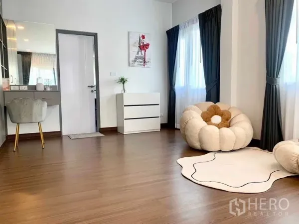 Detached House for rent or sale in Bang Phli, Samut Prakan - Spacious multipurpose room with vanity desk, plush lounge chair and large windows.