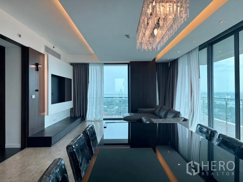 Condominium for rent - Open-plan living and dining with a crystal chandelier, floor-to-ceiling windows and balcony overlooking the city and Chao Phraya River.