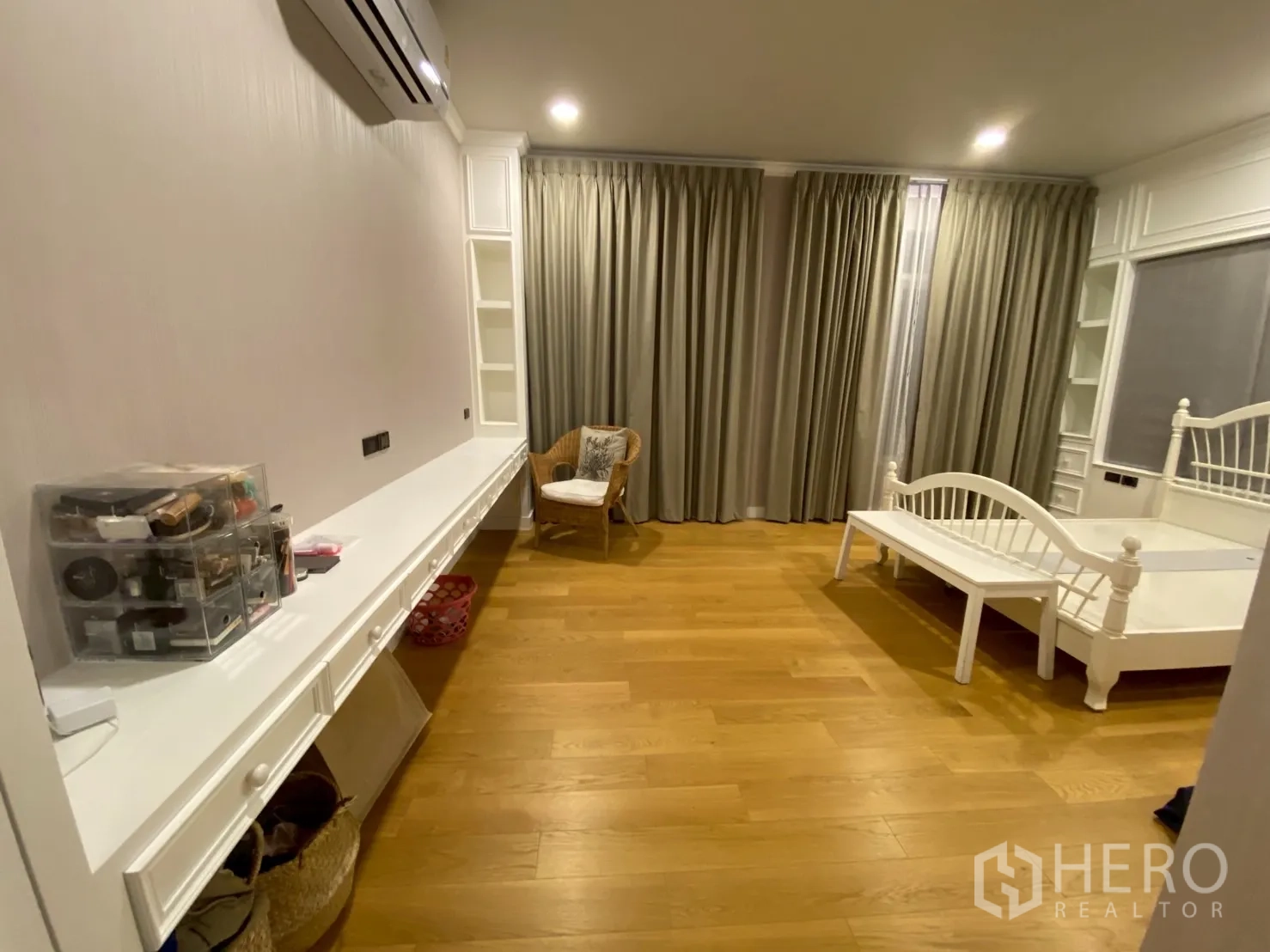 Detached House for sale in Mueang Nakhon Pathom, Nakhon Pathom - Bedroom angle showing a long built-in dressing desk, shelving and wall air conditioner.
