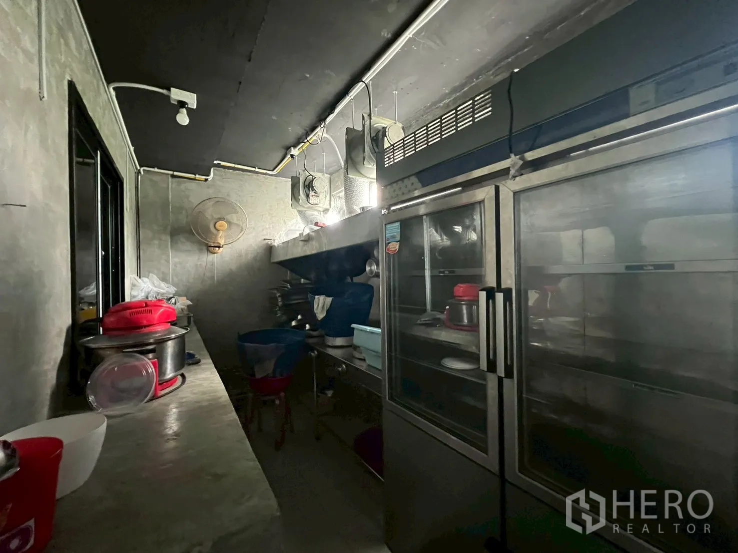 Shophouse for rent - Commercial galley kitchen with stainless refrigerators and prep surfaces.