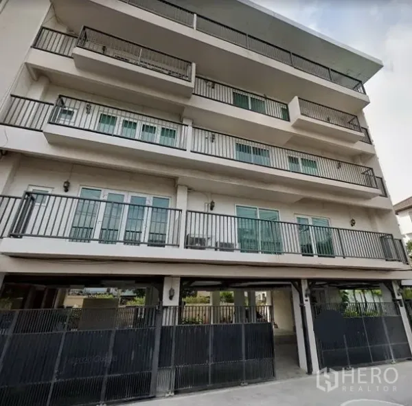 Office Space for rent in Khlong Toei, Bangkok - Multi-storey building exterior with continuous balconies and secure gated parking in Phra Khanong