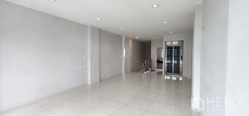 Home Office for rent - Spacious open-plan office floor with white tiles and recessed ceiling lights.