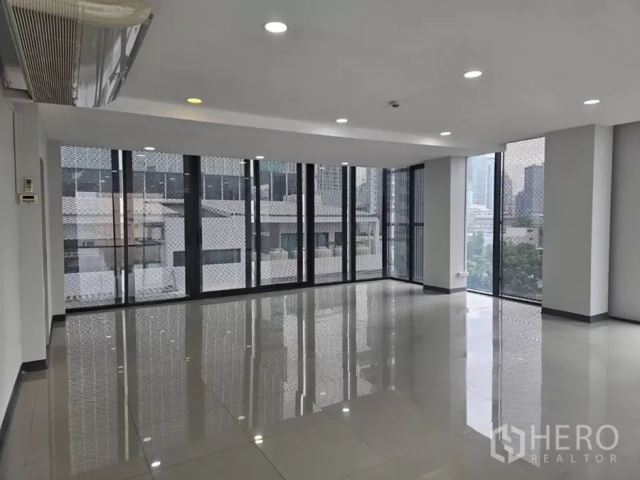 Office Space for rent in Sathon, Bangkok - Bright open-plan office with floor-to-ceiling corner windows, glossy tile floors, and recessed lights in Sathon, Bangkok.