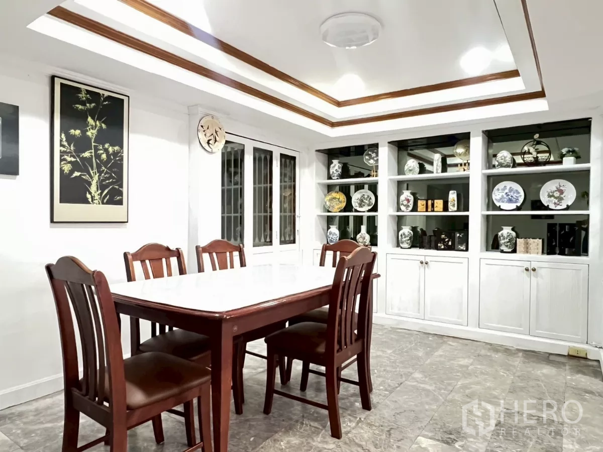 Home Office for rent in Watthana, Bangkok - Dining room with marble-top table and white display cabinetry.