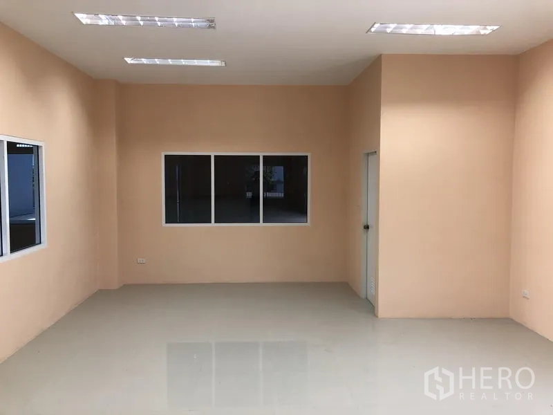 Warehouse for rent in Lat Lum Kaeo, Pathum Thani - Clean office room with windows overlooking the warehouse floor and tiled flooring.