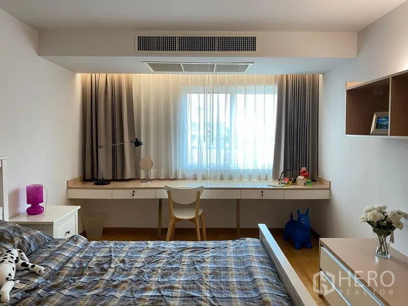 Condominium for sale in Phra Khanong, Bangkok - Bedroom work area featuring a long built-in countertop, window, and wall shelving.