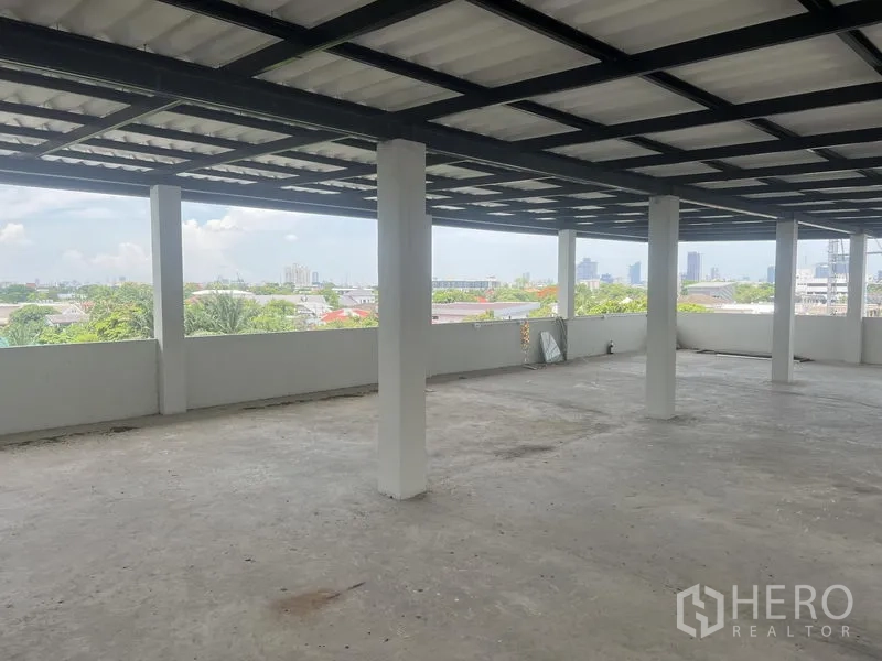 Home Office for rent in Suan Luang, Bangkok - Covered rooftop terrace with open sides and panoramic Bangkok skyline views.