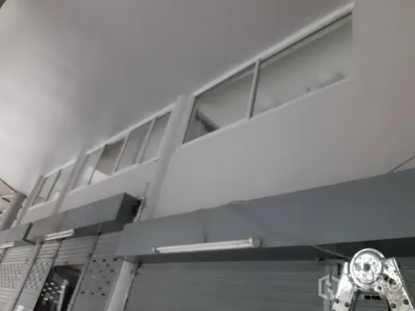 Office Space for rent in Khlong Toei, Bangkok - High-ceiling commercial frontage with roller shutters and upper windows on Sukhumvit.