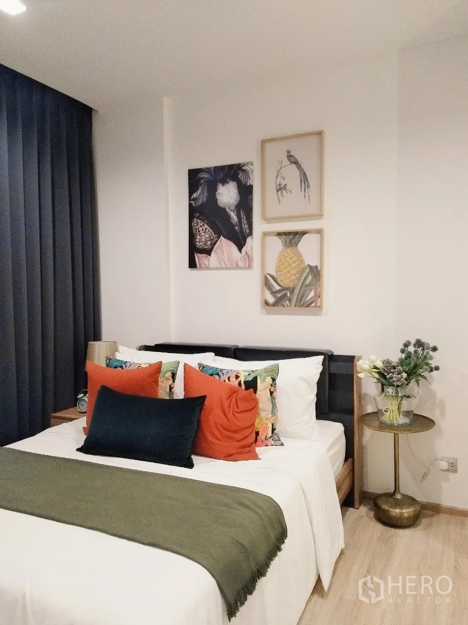 公寓 for rent in Watthana, Bangkok - 温馨卧室，双人床、装饰抱枕、墙面装饰画与床边桌。