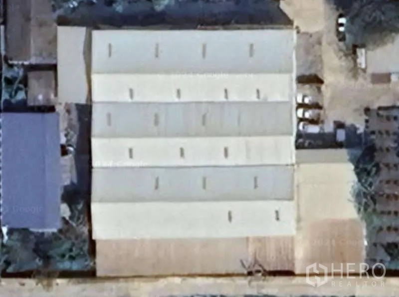 Warehouse for rent or sale in Nong Suea, Pathum Thani - Aerial view of multi-bay warehouse roofs and surrounding yard.