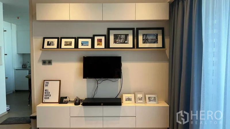 Condominium for sale - Bedroom view to work desk and corridor with wood flooring and glass partition.