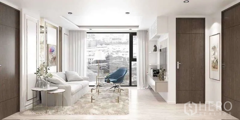 คอนโด ขาย - ภาพเรนเดอร์โถงนั่งเล่นมีโซฟา เก้าอี้อาร์มแชร์ และหน้าต่างกว้าง