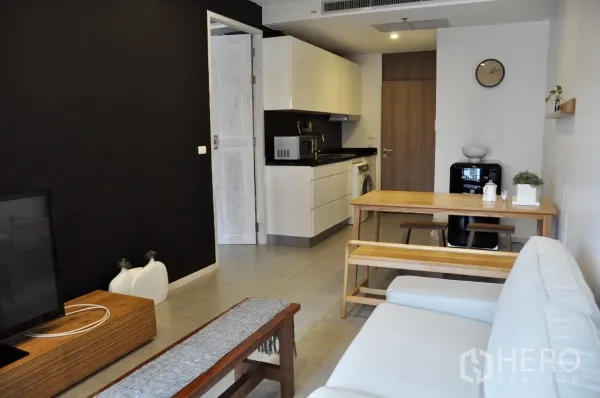 คอนโด ให้เช่าในBangkok - พื้นที่นั่งเล่นเชื่อมครัวขนาดกะทัดรัด ตู้สีขาว ท็อปสีดำ มีเครื่องซักผ้าและตู้เย็นสไตล์วินเทจ