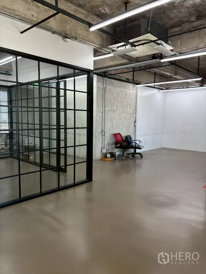Office Space for rent in Watthana, Bangkok - Open area next to the glass partition, exposed concrete ceiling with cassette air-conditioning.