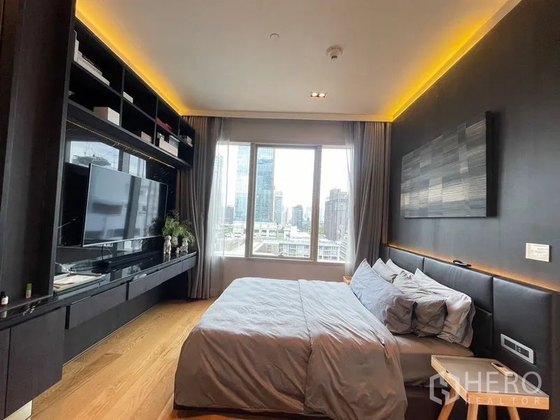 Condominium for rent in Pathum Wan, Bangkok - Second bedroom with backlit headboard, built-in media wall and skyline view.