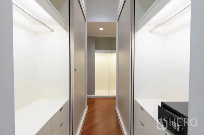Condominium for rent - Walk-in wardrobe corridor with built-in closets, drawers and bright lighting.