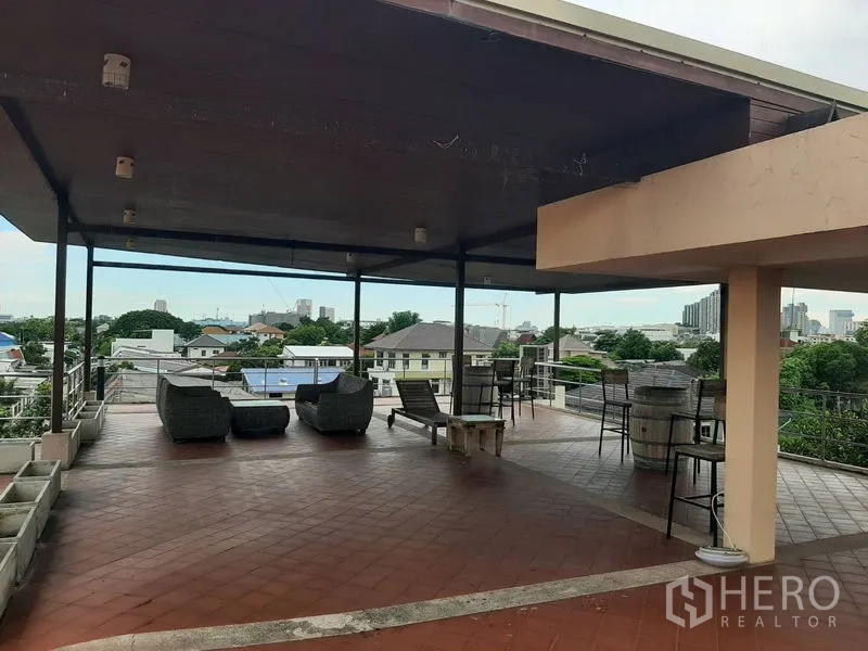 Home Office for sale in Phra Khanong, Bangkok - Covered rooftop terrace with outdoor seating and open city views.