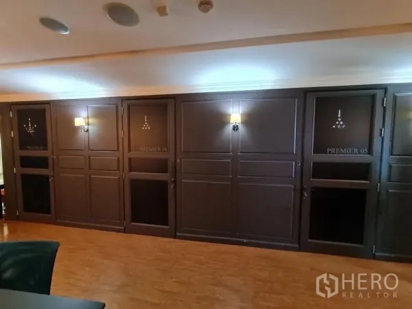 Office Space for rent - Executive office corridor with dark paneled doors, wall sconces and warm wood flooring.