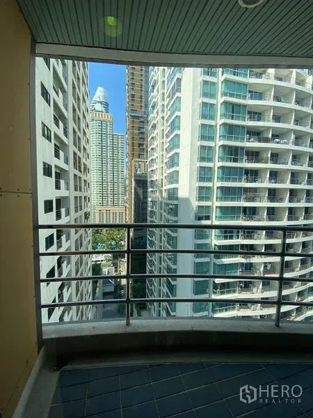 Condominium for rent in Pathum Wan, Bangkok - Balcony view framed by Bangkok high-rise towers.