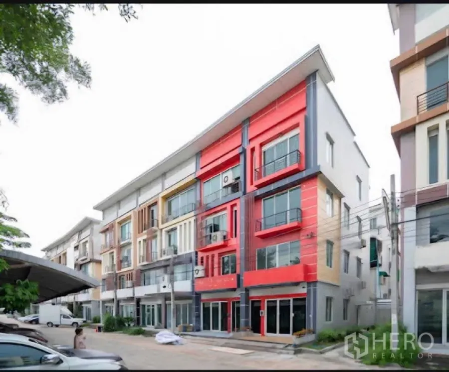 Home Office for rent or sale in Lat Krabang, Bangkok - Front view of a four-storey home office with modern facade and parking area.
