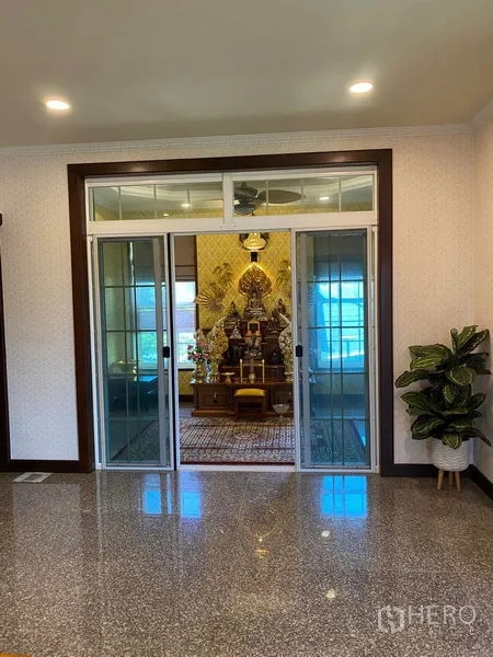 Detached House for sale in Bang Bo, Samut Prakan - Sliding glass doors opening to a dedicated shrine room with ornate decor.