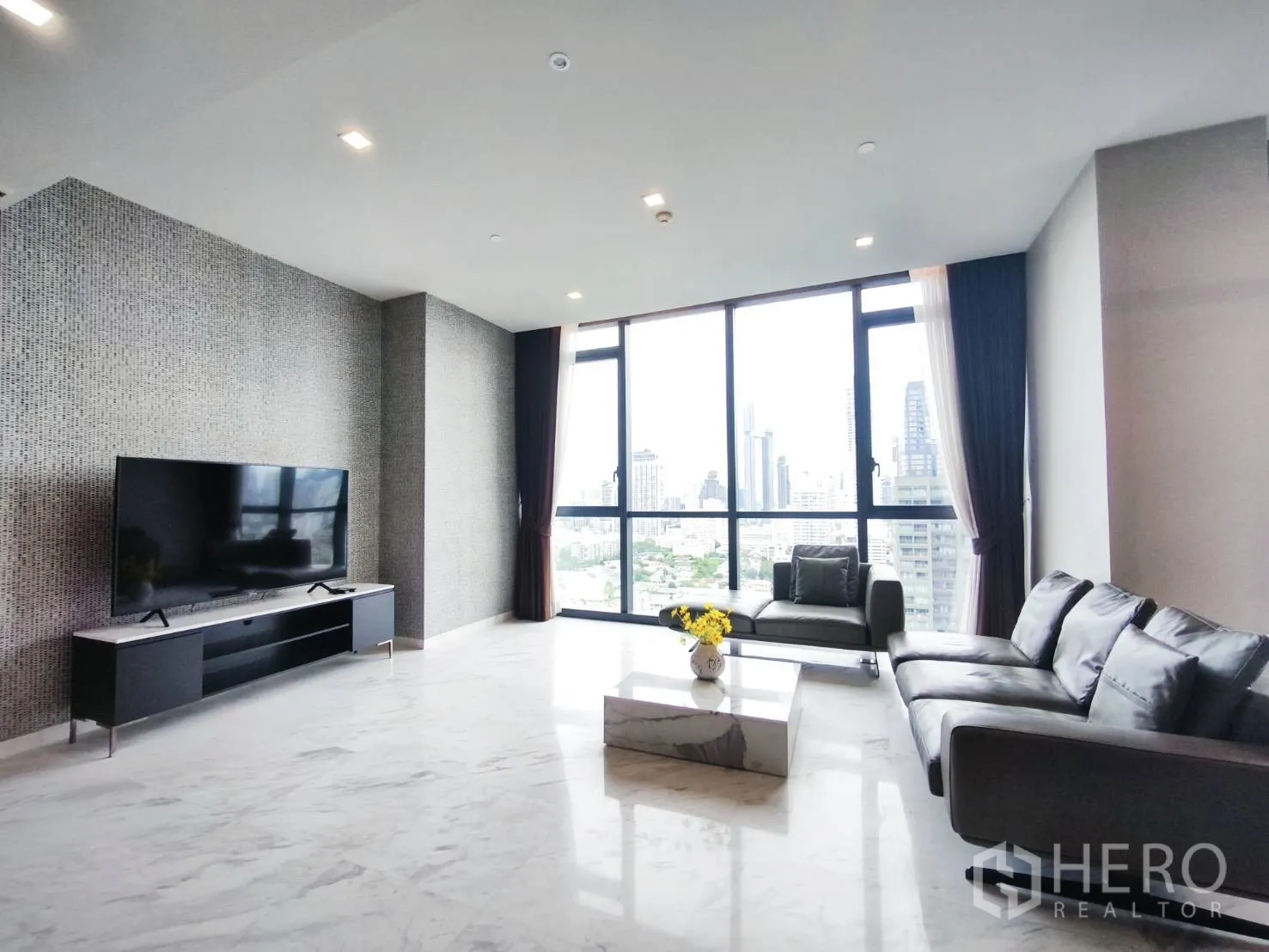 Condominium for rent in Watthana, Bangkok - Living space with TV console, sofa set, and expansive city views.