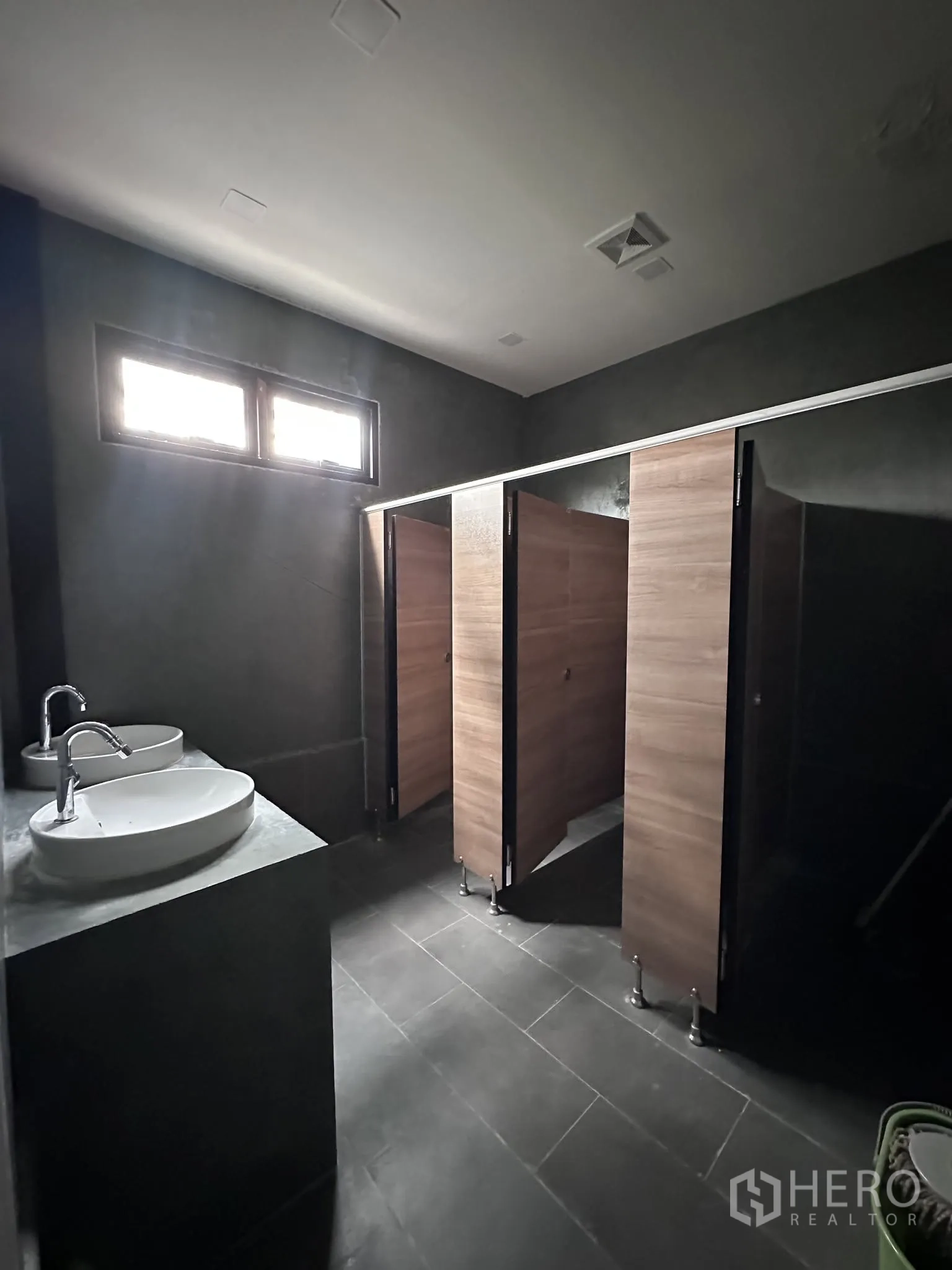 Warehouse for rent or sale in Prawet, Bangkok - Restroom area with basins and multiple toilet stalls inside the facility.