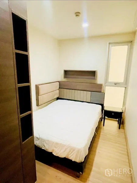 Condominium for rent - Cozy second bedroom with bed and narrow window for natural light.
