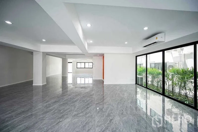 Home Office for rent in Suan Luang, Bangkok - Large office floor with recessed lighting and sliding glass wall opening to a narrow landscaped strip.