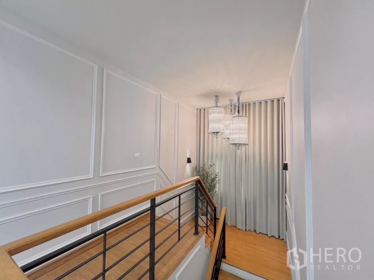 Detached House for rent in Bang Phli, Samut Prakan - Upper landing with decorative wall panels and hanging crystal lights.