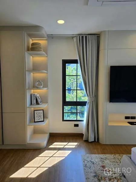 Detached House for rent in Bang Phli, Samut Prakan - Bedroom corner with illuminated shelves, TV wall and curtained window.
