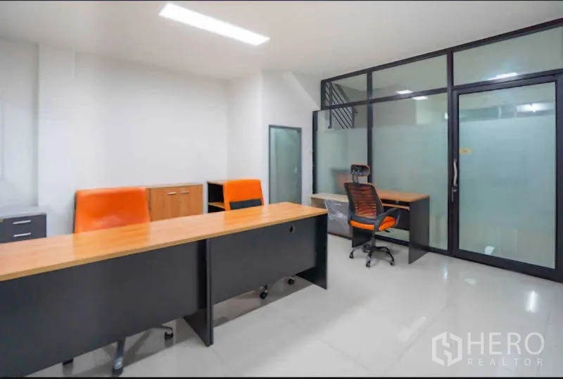 Home Office for rent or sale in Lat Krabang, Bangkok - Office area with frosted glass partition and orange task chair.