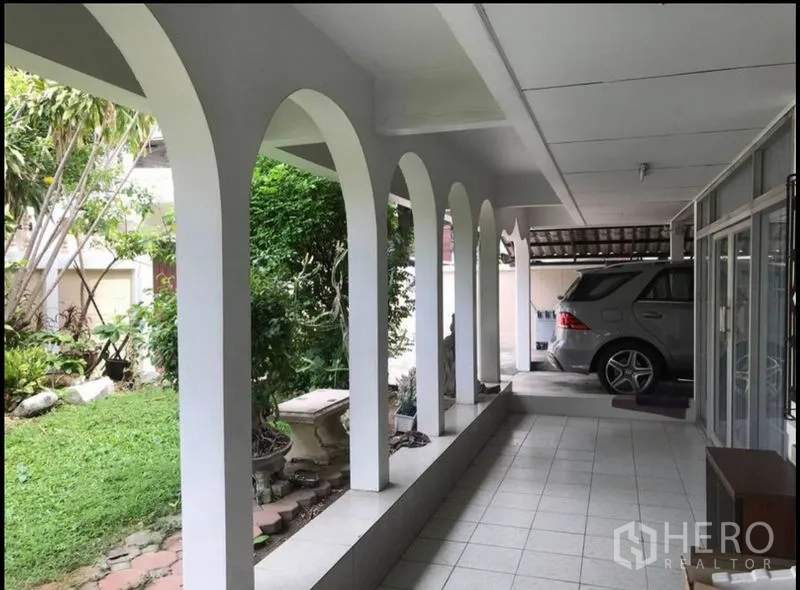 Home Office for rent in Suan Luang, Bangkok - Covered terrace with arches overlooking a small garden and a carport for parking.