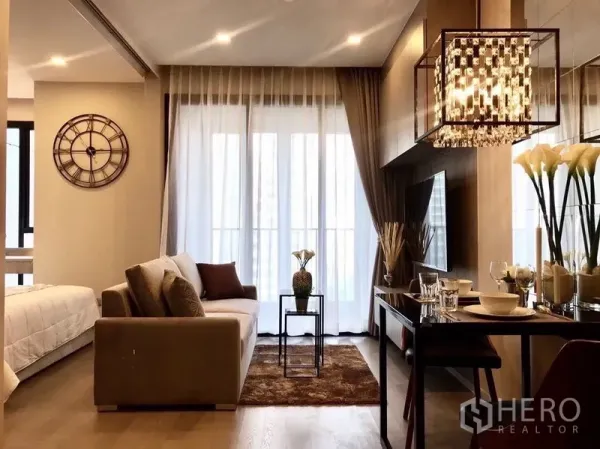 Condominium for rent in Watthana, Bangkok - Modern lounge and dining space with crystal chandelier and floor-to-ceiling balcony doors.
