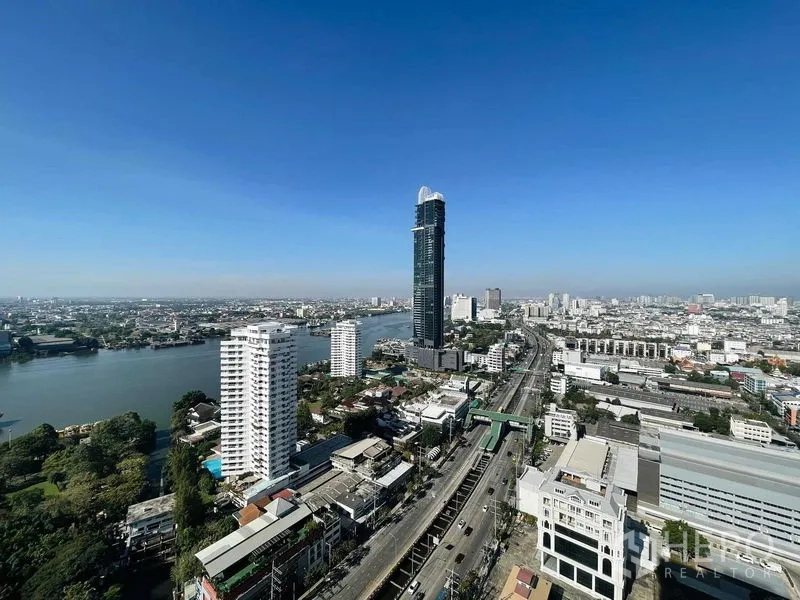 Condominium for rent or sale in Bang Kho Laem, Bangkok - High-floor cityscape of Bang Kho Laem with the Chao Phraya River under a clear blue sky.