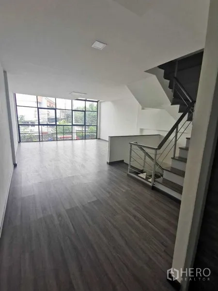 Home Office for rent or sale - Open-plan top floor with staircase and full-height windows.