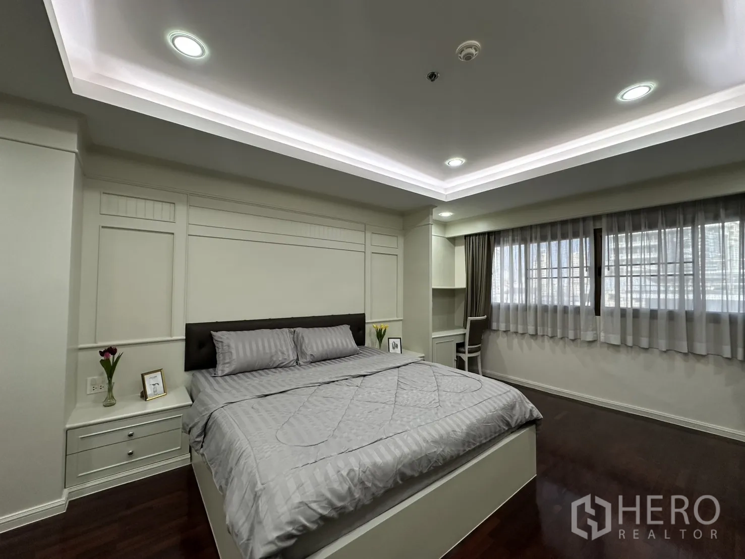 Condominium for rent in Watthana, Bangkok - Bright bedroom with a king bed, large windows, and recessed lights.