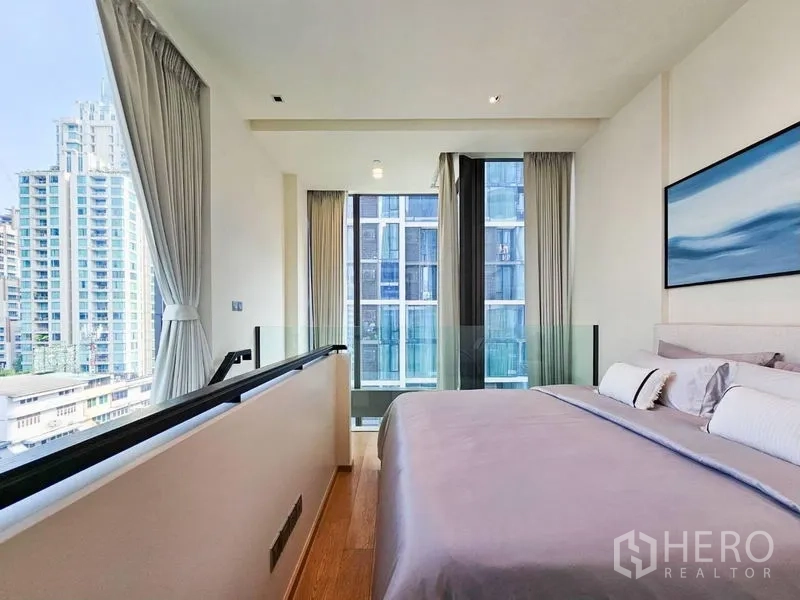 Condominium for rent - Loft-style bedroom facing full-height windows with a view of neighboring towers.