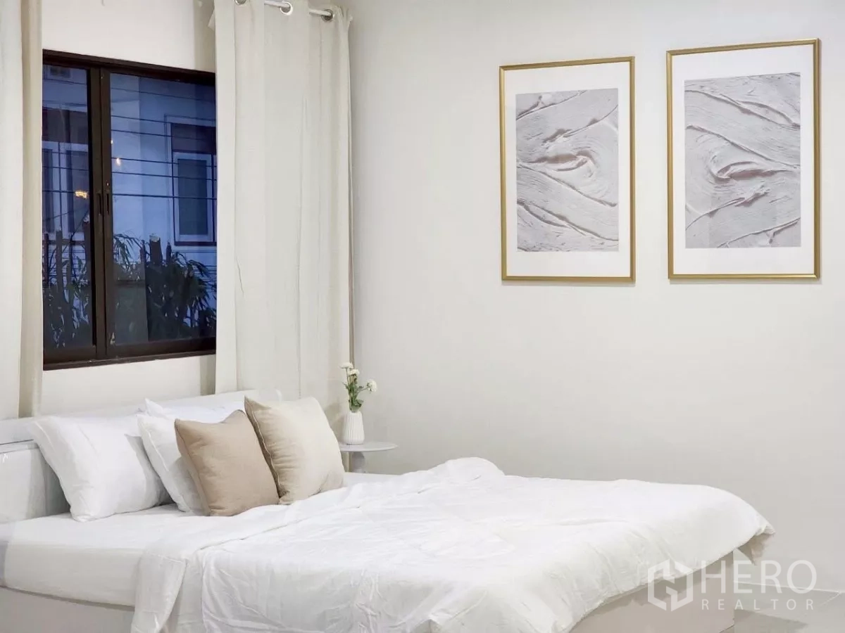 Detached House for rent in Chatuchak, Bangkok - Alternate bedroom angle with framed art and large window with curtains.