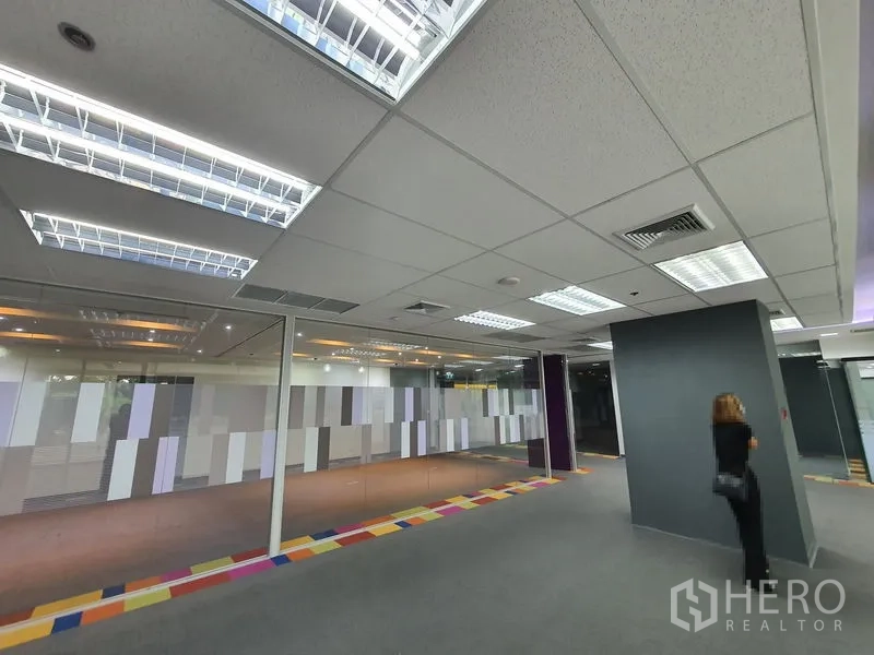 Office Space for rent in Watthana, Bangkok - Bright office floor with glass partitions and fluorescent ceiling panels.