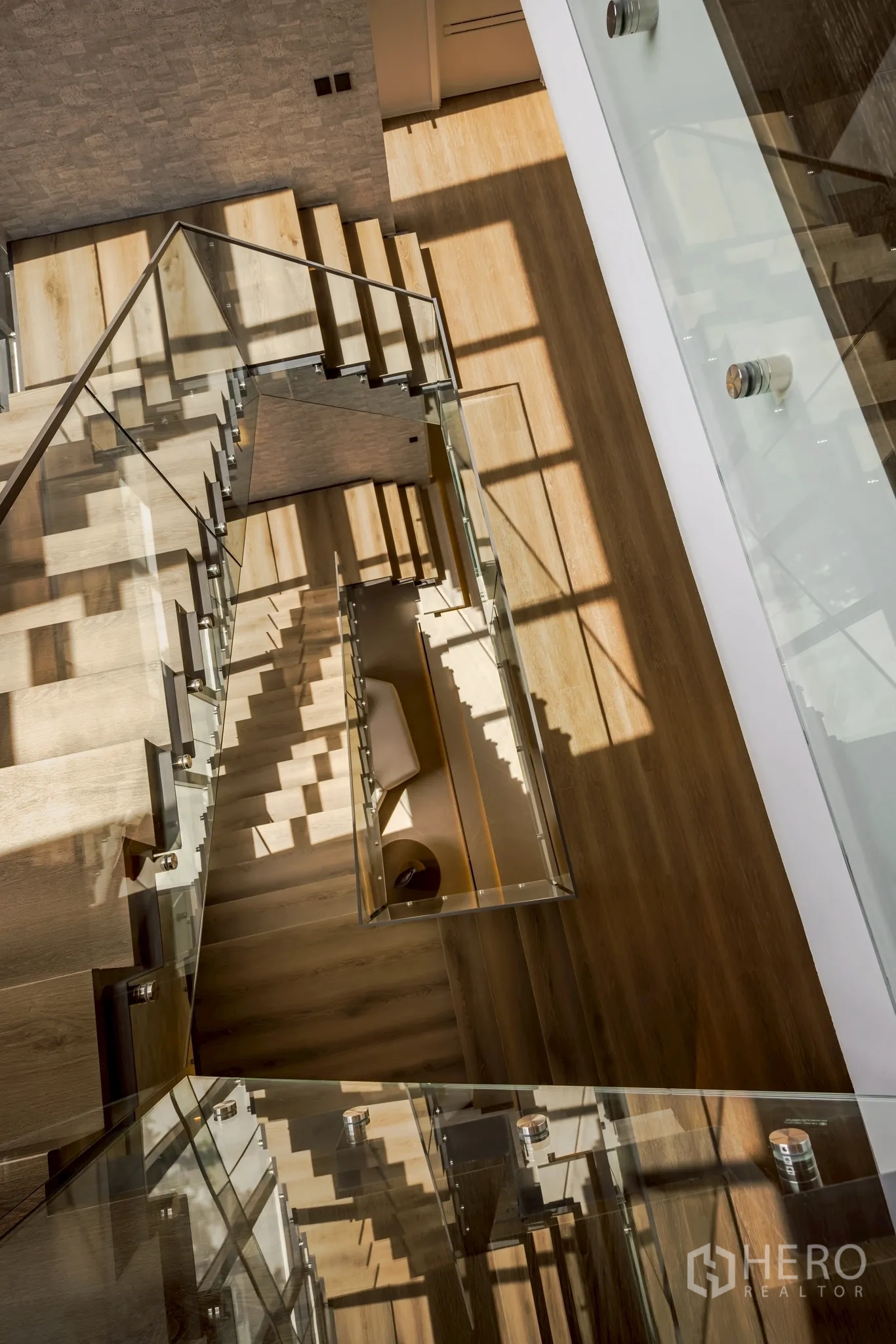 Detached House for rent in Saphan Sung, Bangkok - Top‑down perspective of the staircase with timber treads and glass balustrades.