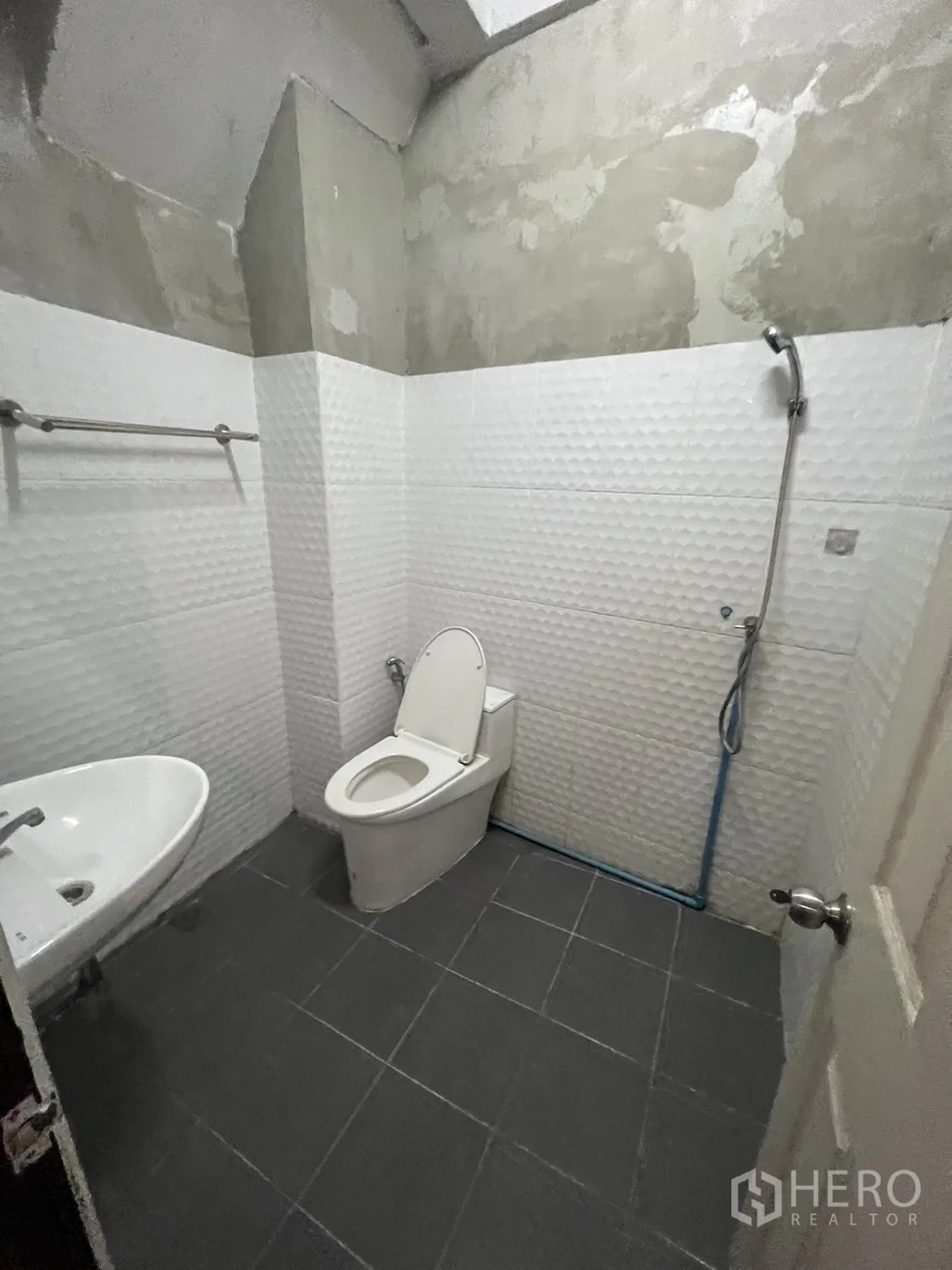 店屋 出租在Watthana, Bangkok - 带花洒的卫生间，白色立体墙砖与灰色地面。