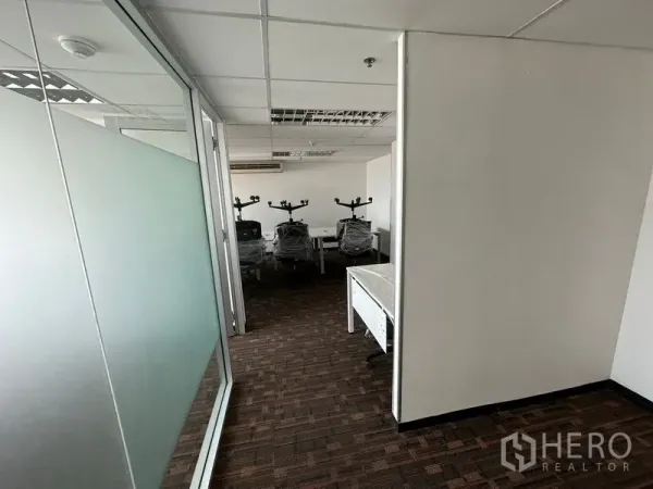 Office Space for rent in Watthana, Bangkok - Hallway with frosted glass partition leading to team work area.