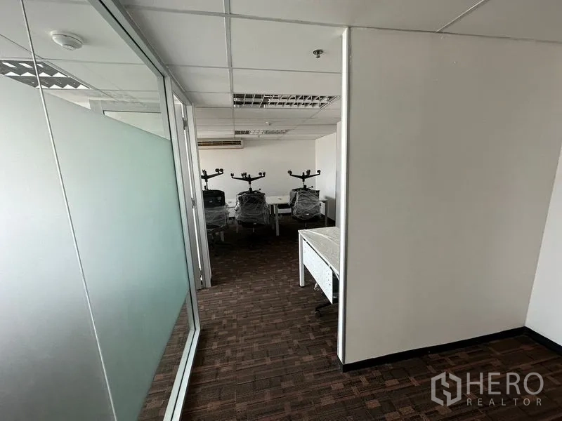 Office Space for rent in Watthana, Bangkok - Hallway with frosted glass partition leading to team work area.