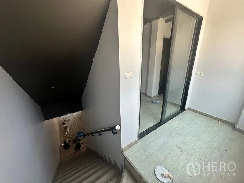 Home Office for rent - Stairwell landing with sliding glass door leading to upper office rooms.