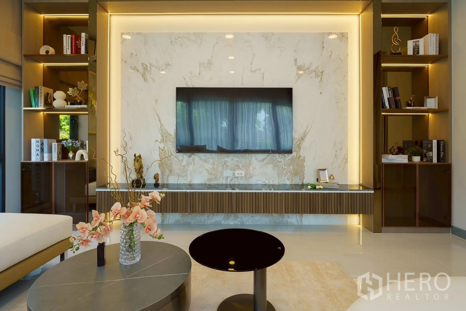 Detached House for sale in Bang Phli, Samut Prakan - Luxury living room with marble TV wall and illuminated built-in shelves